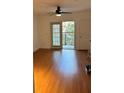 Bright living room with wood-look floors and access to a private balcony at 304 E South St # 4027, Orlando, FL 32801