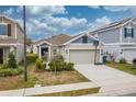 House exterior featuring a two-car garage and basketball hoop at 522 Jett Ln, Davenport, FL 33837