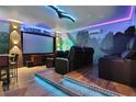 Jurassic World themed home theater with tiered seating and large screen at 3545 Lavender Dr, Davenport, FL 33897