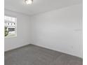 Bright bedroom with gray carpet and large window at 1353 Hanoverian Dr, Lake Alfred, FL 33850
