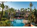 Large resort-style pool with multiple areas, palm trees, and clubhouse at 2909 Calabria Ave, Davenport, FL 33837