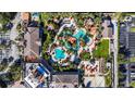 Aerial view of resort amenities including pools, parking, and clubhouse at 2909 Calabria Ave, Davenport, FL 33837