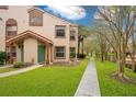 Townhouse exterior with walkway and landscaping at 5460 E Michigan St # 7, Orlando, FL 32812