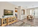 Open concept dining area with hardwood floors and a view to the living room at 7768 Linkside Loop, Reunion, FL 34747