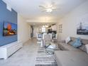 Spacious living room with sectional sofa and large TV at 4721 Clock Tower Dr # 304, Kissimmee, FL 34746