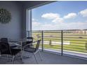 Private balcony with table and chairs overlooking a scenic view at 4721 Clock Tower Dr # 304, Kissimmee, FL 34746