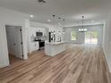 Modern kitchen with island, stainless steel appliances, and white cabinets at 14759 Sw 43Rd Terrace Rd, Ocala, FL 34473