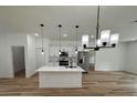 Modern kitchen with island, stainless steel appliances, and white cabinets at 14759 Sw 43Rd Terrace Rd, Ocala, FL 34473
