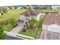 Two-story house with tile roof, palm trees, and driveway at 1658 Lake Side Ave, Davenport, FL 33837