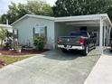 Mobile home with carport and landscaping at 263 Sue Ave, Davenport, FL 33897