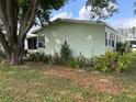 Side view of mobile home with mature tree at 263 Sue Ave, Davenport, FL 33897