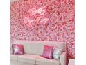 Living room features a pink rose wall and comfy seating at 3191 Paradox Cir # 202, Kissimmee, FL 34746