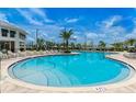 Community pool with lounge chairs and a relaxing atmosphere at 3191 Paradox Cir # 202, Kissimmee, FL 34746