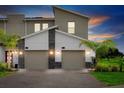 Contemporary two-story home with a two-car garage and attractive landscaping at 897 Ocean Course Ave # 102, Davenport, FL 33896