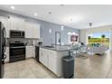 Open concept kitchen with stainless steel appliances and an island at 897 Ocean Course Ave # 102, Davenport, FL 33896