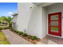 Modern red front door and walkway leading to the entrance of the home at 897 Ocean Course Ave # 102, Davenport, FL 33896