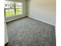 Bright bedroom with carpeted floors and large window at 530 Tanaro Ln, Haines City, FL 33844
