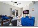 Living room with sectional sofa and large TV at 4564 Ada Ln, Kissimmee, FL 34746