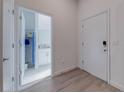 Bright entryway with wood-look floors, leading to a bathroom and laundry area at 633 Trikomo Dr, Davenport, FL 33896