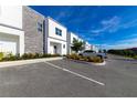 Modern townhouses with gray stone and white siding, ample parking at 633 Trikomo Dr, Davenport, FL 33896