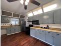 Updated kitchen featuring gray cabinets, wood floors, and modern appliances at 1414 Johns Ave, Haines City, FL 33844