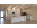 Modern kitchen featuring white cabinets and a large island at 204 Barrington Dr, Haines City, FL 33844