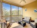 Spacious screened balcony with comfortable seating and lake view at 9055 Treasure Trove Ln # 204, Kissimmee, FL 34747