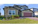 Two-story house with landscaping and two-car garage at 5692 Camilla St, St Cloud, FL 34771
