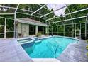 Inviting pool and spa with a screened patio and pool house at 310 Vista Oak Dr, Longwood, FL 32779