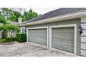 Two-car garage with gray doors at 310 Vista Oak Dr, Longwood, FL 32779