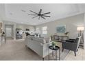 Open concept living room and kitchen with stainless steel appliances and neutral decor at 196 Aidans Lndg, Haines City, FL 33844