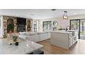 Open concept living space with a stone fireplace and kitchen island at 4041 Yacht Ct, Winter Park, FL 32792
