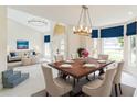 Elegant dining room with a large table, chandelier, and access to living area at 2111 Turnberry Dr, Oviedo, FL 32765