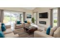 Spacious living room with comfortable seating, fireplace, and large TV at 2111 Turnberry Dr, Oviedo, FL 32765