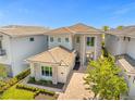 Luxury home with tile roof, stone accents, and paver driveway at 967 Jack Nicklaus Ct, Kissimmee, FL 34747