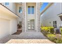 Modern home entrance with stone facade and double front doors at 967 Jack Nicklaus Ct, Kissimmee, FL 34747