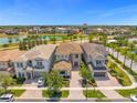 Community view showcasing upscale homes and a tranquil lake at 967 Jack Nicklaus Ct, Kissimmee, FL 34747
