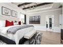 Spacious main bedroom with a plush bed, elegant decor, and an ensuite bathroom at 5043 Prairie Preserve Run, St Cloud, FL 34772