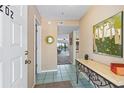 Bright condo entryway with decorative art and console table at 466 Bouchelle Dr # 202, New Smyrna Beach, FL 32169