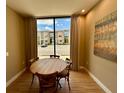 Bright dining area with wood table and four chairs, overlooking the community at 7484 Brooklyn Dr, Kissimmee, FL 34747