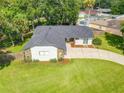 Single-story home with a dark roof, driveway, and spacious lawn at 3130 Willow Oak Dr, Edgewater, FL 32141