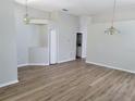 Open living room with wood-look floors and neutral walls at 13620 Waterhouse Way, Orlando, FL 32828