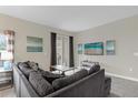 Spacious living room with sectional sofa and TV at 770 Pebble Beach Dr, Davenport, FL 33896