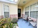 Front porch with seating area, creating a welcoming entrance at 2555 Oneida Loop, Kissimmee, FL 34747