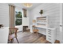 Bright home office with white built-ins, wood floors, and large window at 1953 Spring Shower Cir, Kissimmee, FL 34744