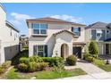 Two-story house with beige siding, landscaping, and a paved walkway at 8907 Caroline Bay Ct, Kissimmee, FL 34747