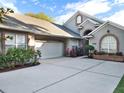 Gray two-story house with a white garage door and landscaping at 1516 Briercliff Dr, Orlando, FL 32806