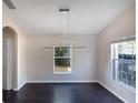 Dining room with dark hardwood floors and a modern light fixture at 221 Rosa Ave, Oviedo, FL 32765