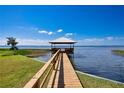 Wooden dock extending into lake with gazebo at 2205 Cypress Cove Dr, Tavares, FL 32778