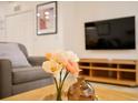 Living room with gray sofa, wooden coffee table, and TV at 3004 Red Ginger Rd, Kissimmee, FL 34747